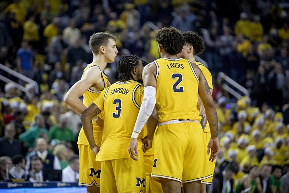 Franz Wagner (21), Zavier Simpson (3), Isaiah Livers (2), and Brandon Johns Jr. (23)