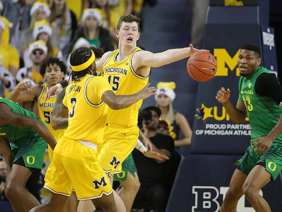 Eli Brooks (55), Zavier Simpson (3), and Jon Teske (15)