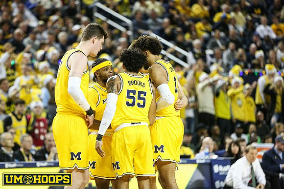 Jon Teske (15), Zavier Simpson (3), Eli Brooks (55), and Isaiah Livers (2)