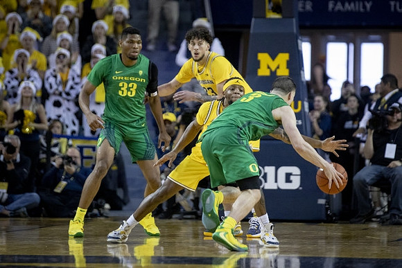 Brandon Johns Jr. (23) and Zavier Simpson (3)