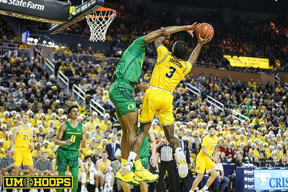 Zavier Simpson (3) and Brandon Johns Jr. (23)