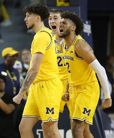 Brandon Johns Jr. (23), Franz Wagner (21), and Isaiah Livers (2)