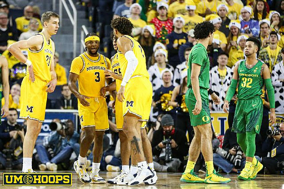 Franz Wagner (21), Zavier Simpson (3), Eli Brooks (55), and Isaiah Livers (2)