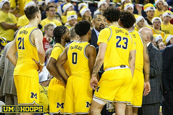 Franz Wagner (21), Zavier Simpson (3), David DeJulius (0), Juwan Howard, Brandon Johns Jr. (23), Isaiah Livers (2), and Phil Martelli
