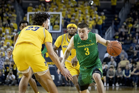 Brandon Johns Jr. (23) and Zavier Simpson (3)