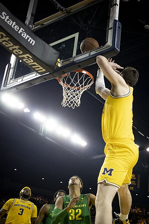 Zavier Simpson (3) and Jon Teske (15)