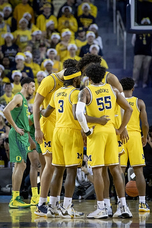 Brandon Johns Jr. (23), Zavier Simpson (3), Eli Brooks (55), Isaiah Livers (2), and David DeJulius (0)