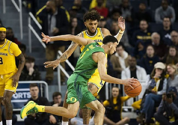 Zavier Simpson (3) and Isaiah Livers (2)
