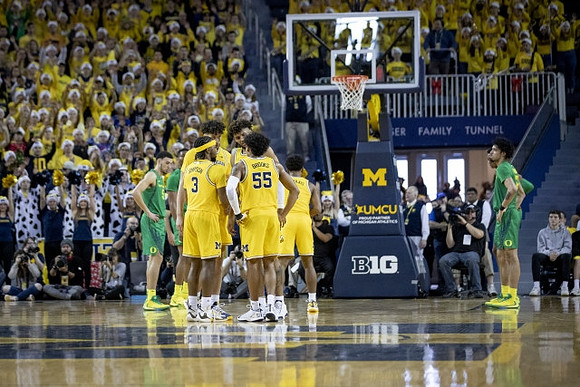 Brandon Johns Jr. (23), Zavier Simpson (3), Eli Brooks (55), Isaiah Livers (2), and David DeJulius (0)