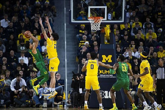 Brandon Johns Jr. (23), David DeJulius (0), and Zavier Simpson (3)