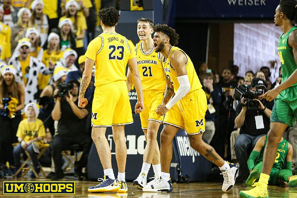 Brandon Johns Jr. (23), Franz Wagner (21), and Isaiah Livers (2)