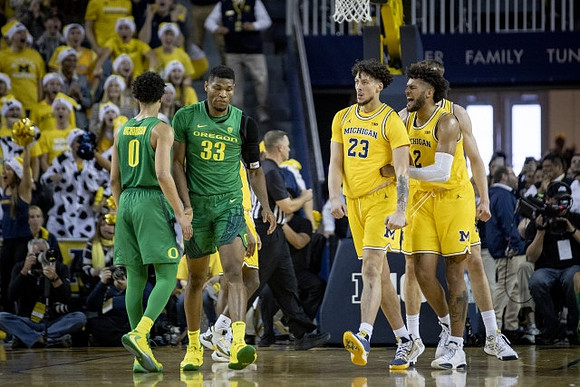 Brandon Johns Jr. (23) and Isaiah Livers (2)
