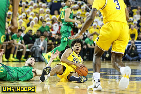 Eli Brooks (55) and Zavier Simpson (3)