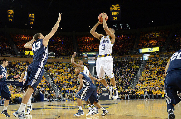 Trey Burke (3) and Glenn Robinson III (1)