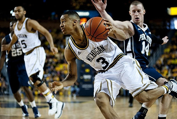 Jon Horford (15) and Trey Burke (3)