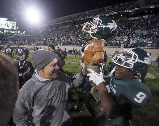 Michigan State Head Coach Mark Dantonio and Paul Bunyan Trophy
