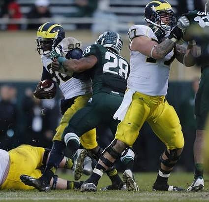 Devin Gardner (98) and Taylor Lewan (77)