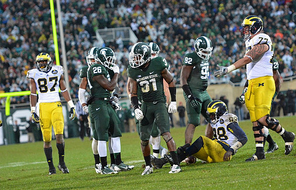 Devin Funchess (87), Devin Gardner (98), and Taylor Lewan (77)