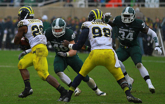 Fitzgerald Toussaint (28) and Devin Gardner (98)