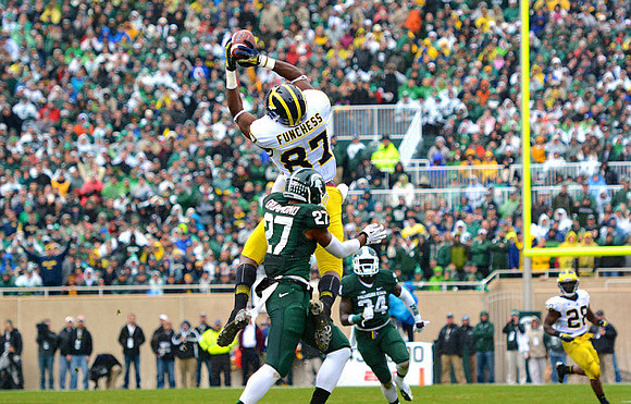 Devin Funchess (87) and Fitzgerald Toussaint (28)