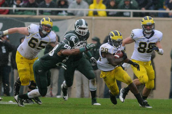 Kyle Bosch (65),  Fitzgerald Toussaint (28), and Jake Butt (88)