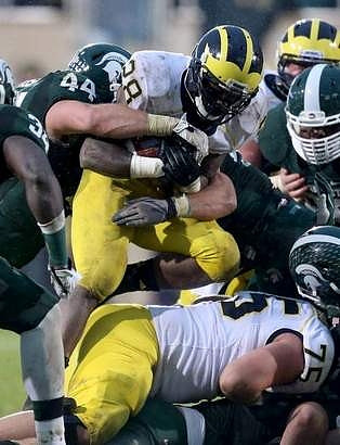 Fitzgerald Toussaint (28) and Michael Schofield (75)