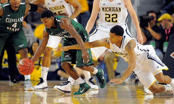 Jon Horford (15), Blake McLimans (22), and Trey Burke (3)