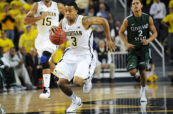 Jon Horford (15) and Trey Burke (3)