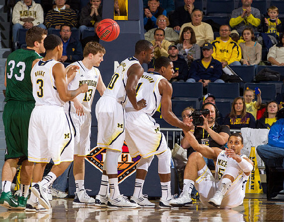 Trey Burke (3), Matt Vogrich (13), Tim Hardaway Jr. (10), Glenn Robinson III (1), and Jordan Morgan (52)