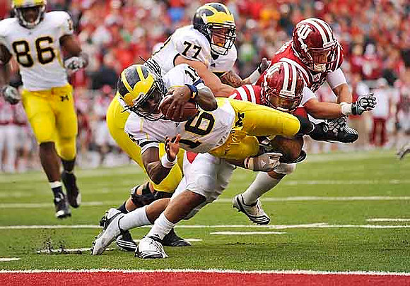 Kevin Koger (86), Denard Robinson (16), and Taylor Lewan (77)