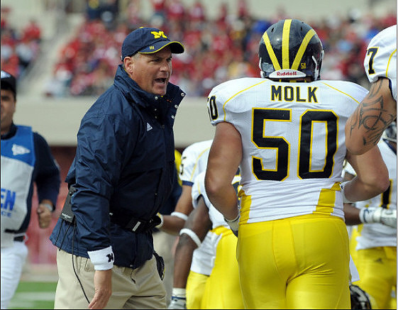Rich Rodriguez, David Molk (50), and Taylor Lewan (77)