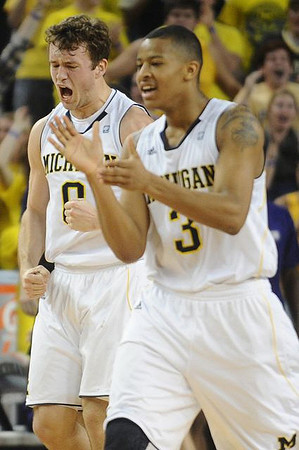 Zack Novak (0) and Trey Burke (3)