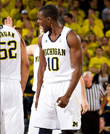 Jordan Morgan (52), Tim Hardaway Jr. (10), and Zack Novak (0)
