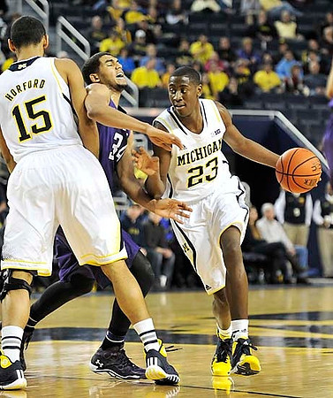 Jon Horford (15) and Caris LeVert (23)
