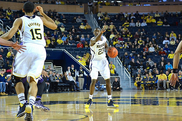 Jon Horford (15) and Caris LeVert (23)