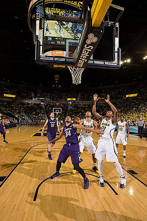 Jon Horford (15), Zak Irvin (21), and Derrick Walton Jr. (10)