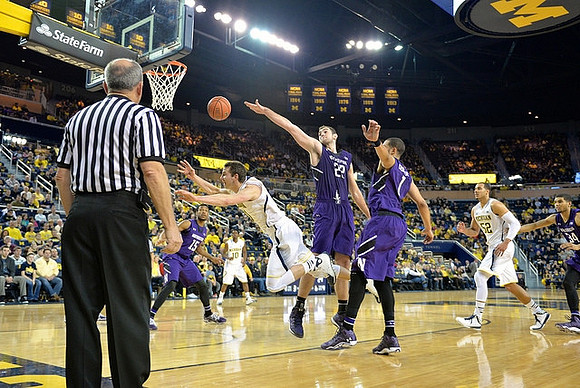 Nik Stauskas (11), Derrick Walton Jr. (10), and Jordan Morgan (52)