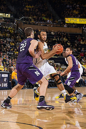 Jon Horford (15) and Caris LeVert (23)