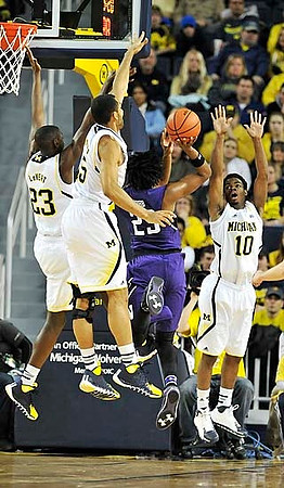 Caris LeVert (23), Jon Horford (15), and Derrick Walton Jr. (10)