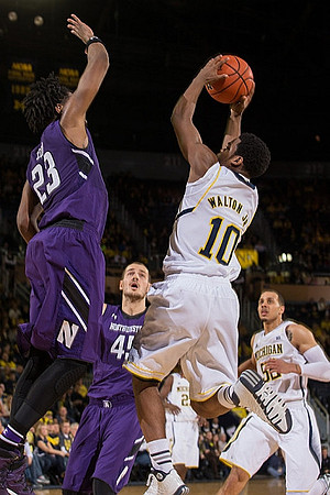 Derrick Walton Jr. (10), Jordan Morgan (52), and Caris LeVert (23)