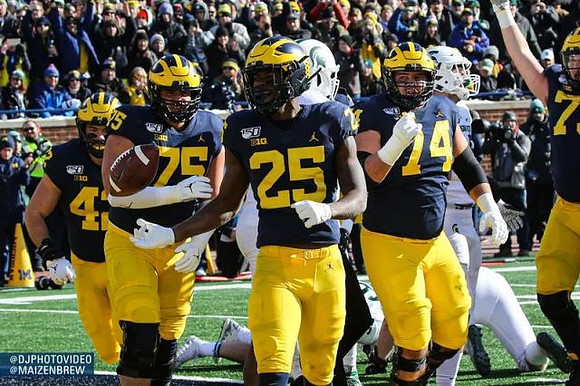 Ben Mason (42), Jon Runyan Jr. (75), Hassan Haskins (25), and Ben Bredeson (74)
