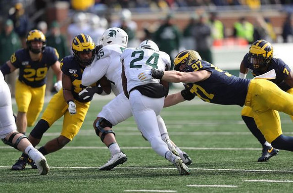 Jordan Glasgow (29), Josh Metellus (14), Aidan Hutchinson (97), and Khaleke Hudson (7)