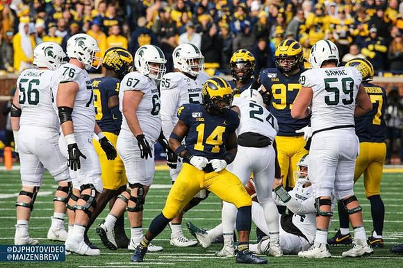 Kwity Paye (19), Josh Metellus (14), Aidan Hutchinson (97), and Khaleke Hudson (7)