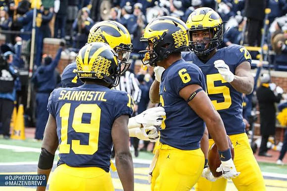 Mike Sainristil (19), Tarik Black (7), Cornelius Johnson (6), and Hassan Haskins (25)
