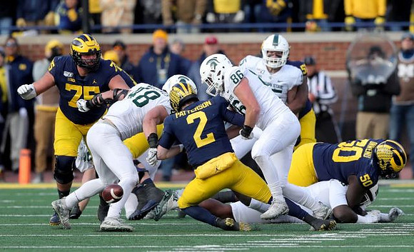 Jon Runyan Jr. (75), Shea Patterson (2), and Michael Onwenu (50)