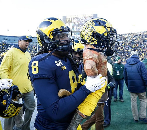 Grant Newsome, Devin Gil (8), and Paul Bunyan Trophy
