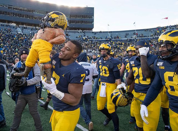 Paul Bunyan Trophy, Khaleke Hudson (7), Dylan McCaffrey (10), Brad Hawkins (20), and Devin Gil (8)
