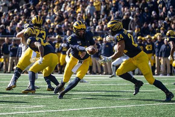 Jalen Mayfield (73), Hassan Haskins (25), Shea Patterson (2), and Zach Charbonnet (24)