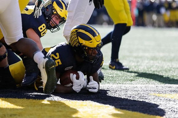 Ryan Hayes (80) and Hassan Haskins (25)