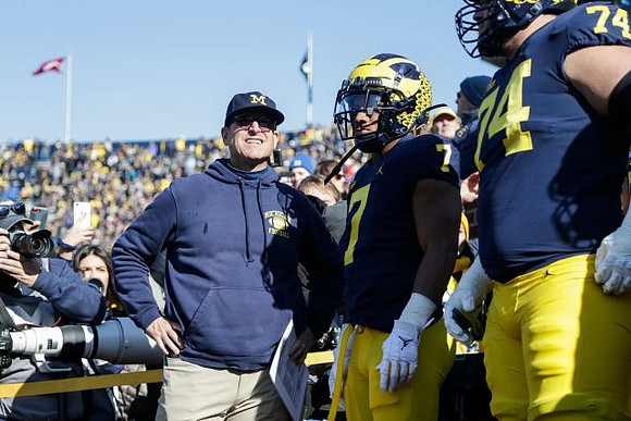Jim Harbaugh, Khaleke Hudson (7), and Ben Bredeson (74)